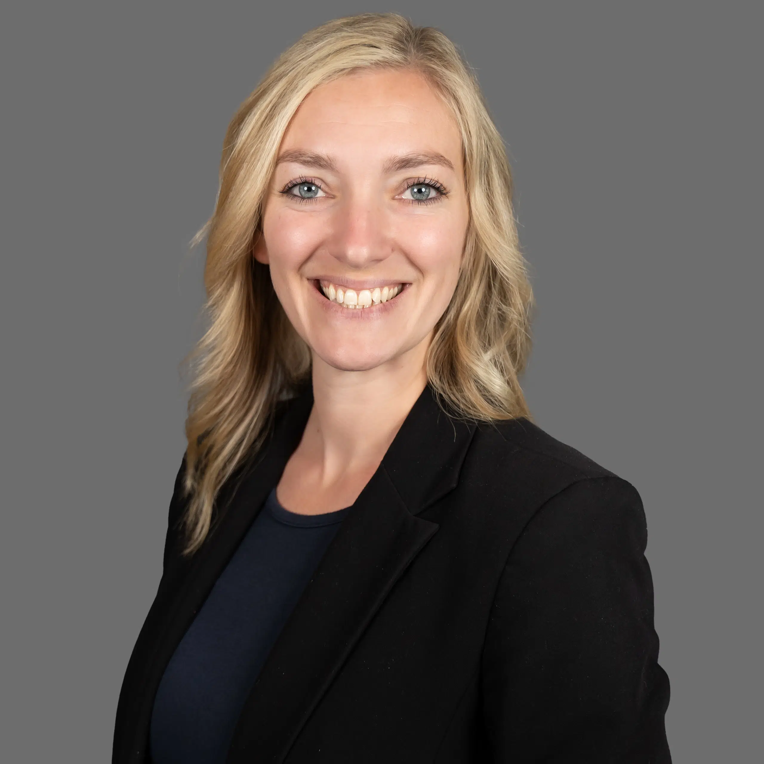 katie aubart smiling in a suit coat
