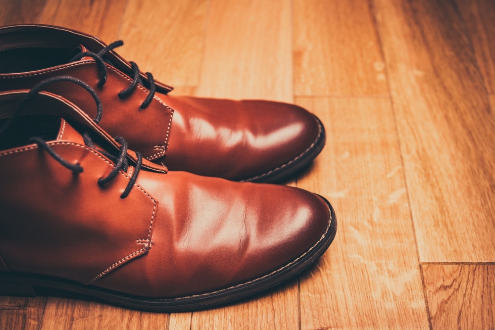 brown leather shoes on a wood floor