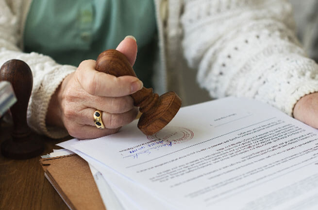 grandparent stamping her estate planning papers