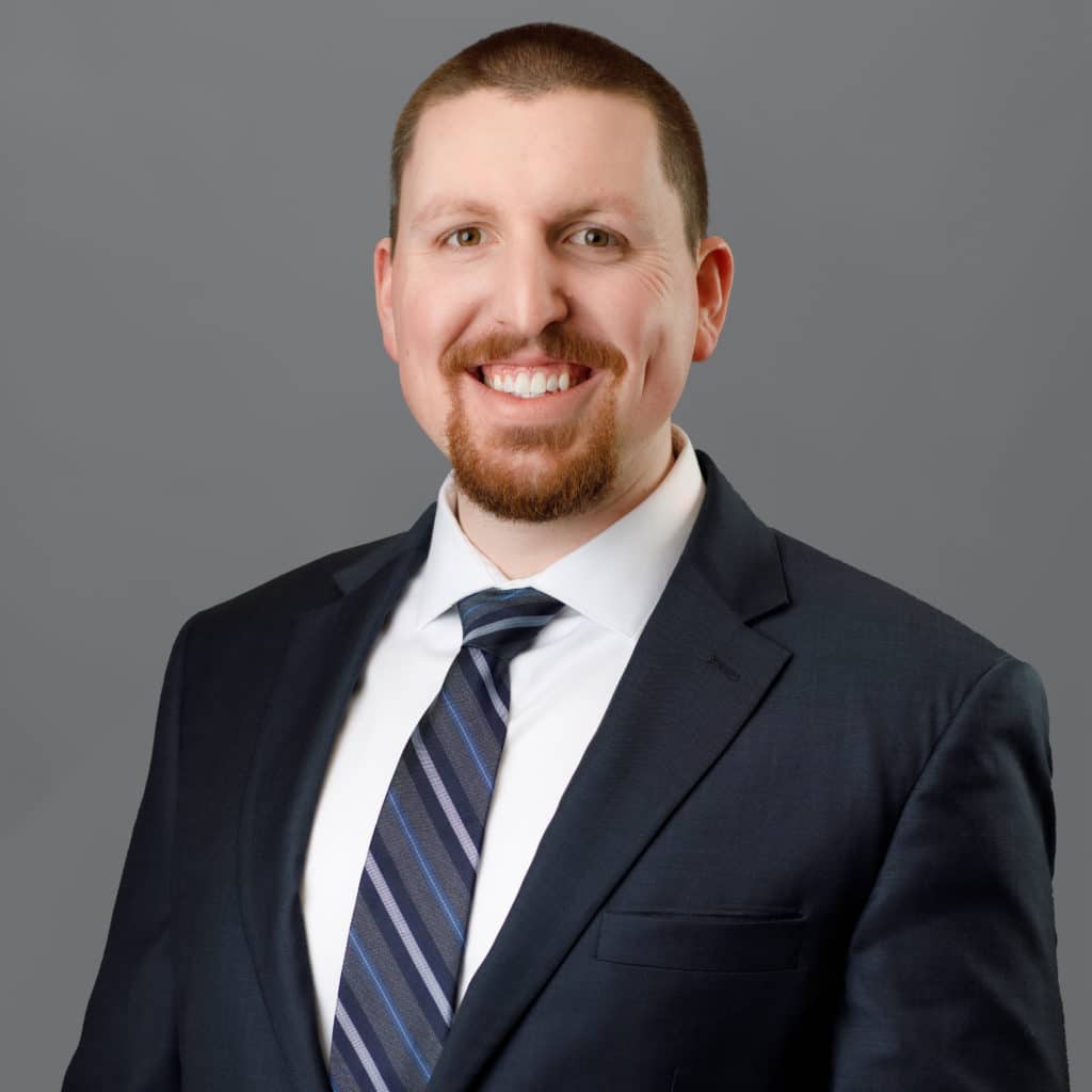 tenner stoe smiling in a suit