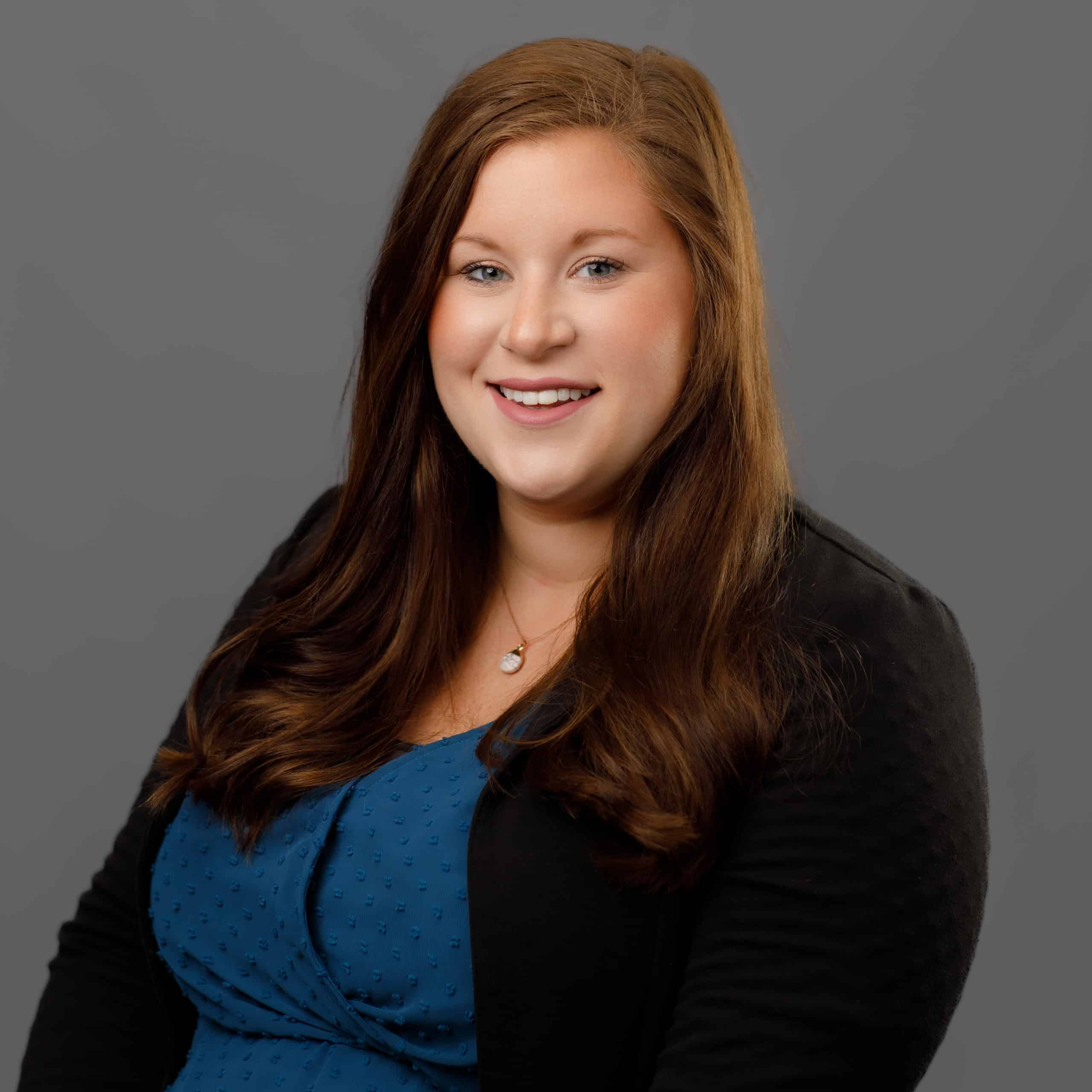 leah janicki smiling in a suit coat